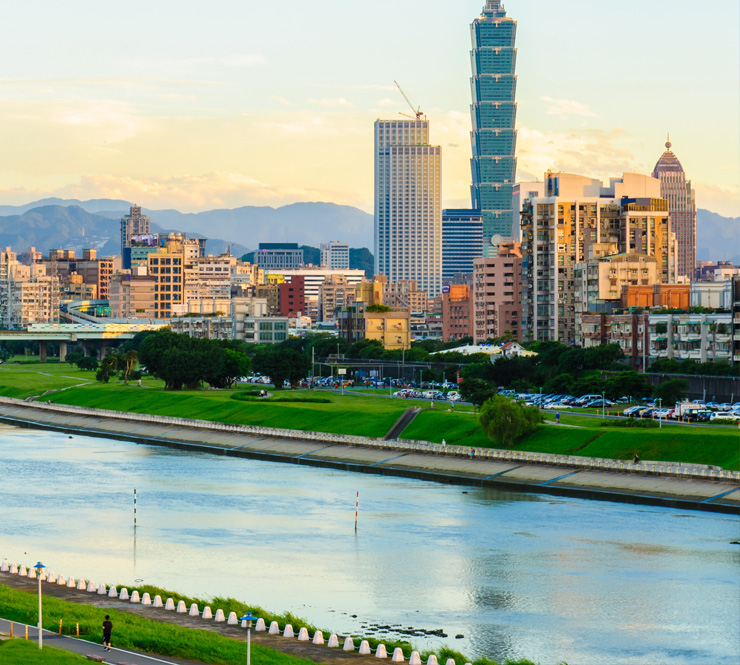 Landscape shot of a bridge over the Tamsui River and city buildings in Taipei, Taiwan