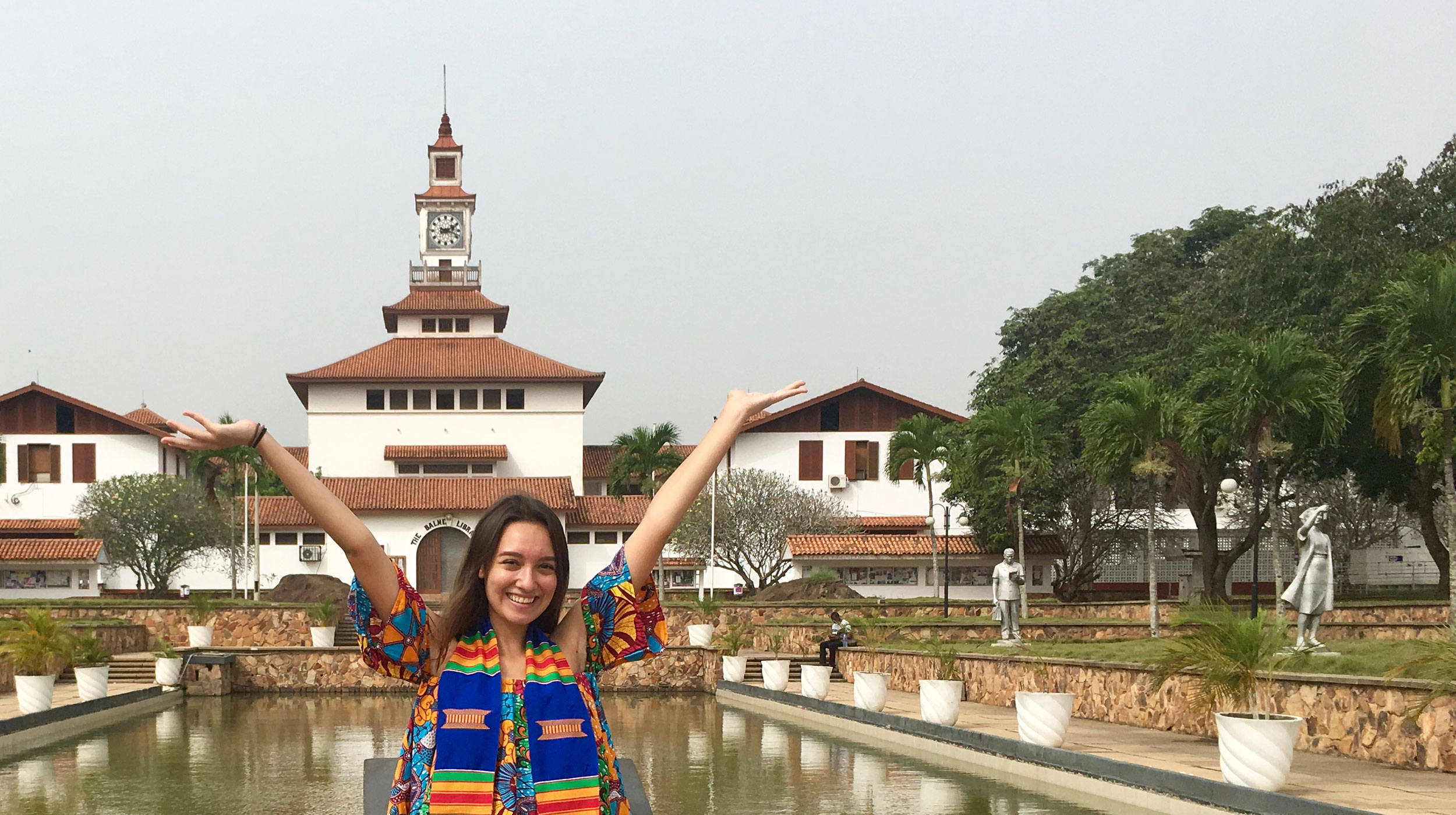 UCEAP student smiling with her arms up in Ghana. 