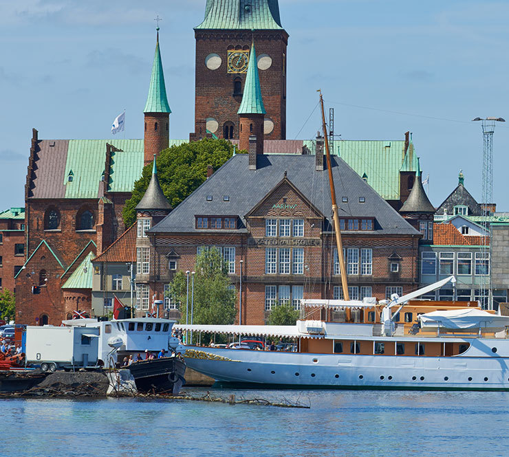 Her Royal Majesty's Yacht Dannebrog docked in the harbor on a beautiful day in Aarhus, Denmark.