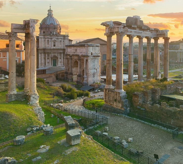 View of the Ruins of Roman Forum during sunrise with the Arch of Septimius Severus, the Temple of Saturn, the colonnade of Basilica Julia, and the Temple of Castor and Pollux in Rome, Italy. 