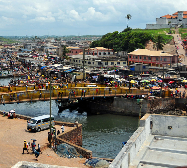 View of busy shoppers around the town and the creek in Elmina Ghana. 