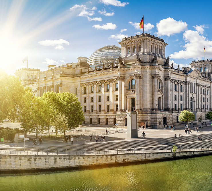 View of the Reichstag building the Spree River on a beautiful summer day in Berlin, Germany.