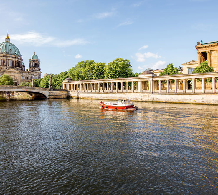 Tourist ship passing Museum Island and Berlin Cathedral on River Spree in Berlin, Germany. 
