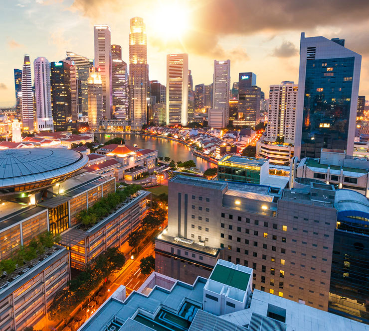 Panoramic view of the Singapore Skyline and Marina Bay at sunset. 