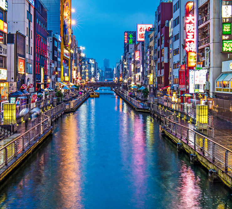 The colourful neon billboards illuminating the restaurants, bars and nightlife of Dotonbori, reflecting in the canal in the heart of Osaka, Japan