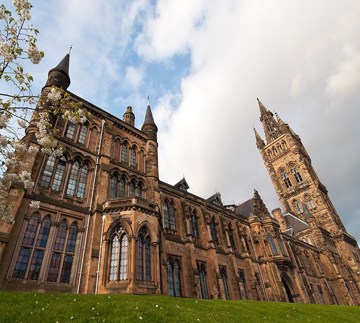 Looking up at the exterior of the main building of the University of Glasgow, Scotland.