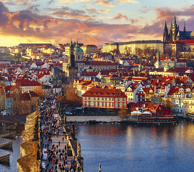 Sunset view above Charles Bridge, the Prague Castle and the Vltava river in Prague, Czech Republic.