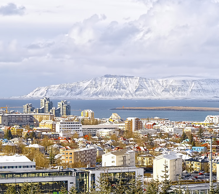 View from above of Reykjavik, Iceland with mountains Akrajfall and Esja in the background.