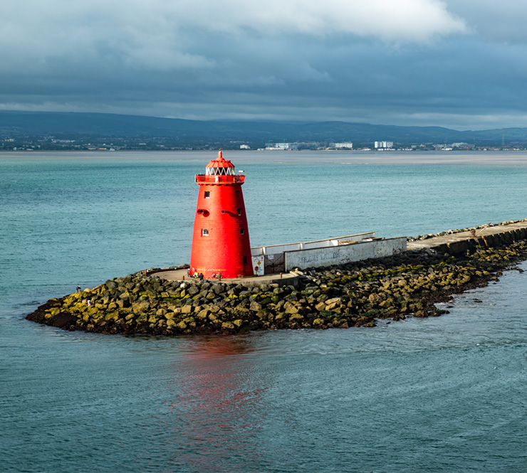 Poolbeg lighthouse at the end of the long breakwater out of Dublin Bay in Ireland. 