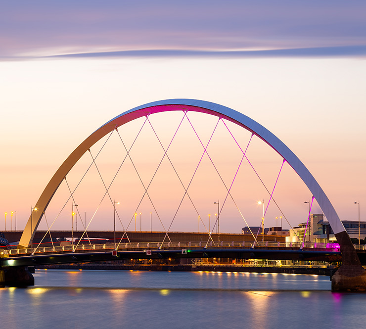 Sunrise reflects on The Clyde Arc over the Clyde River in Glasgow, Scotland