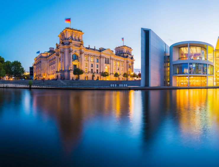 A panoramic view of the German Parliament Building and the River Spree at sunset in Berlin, Germany.