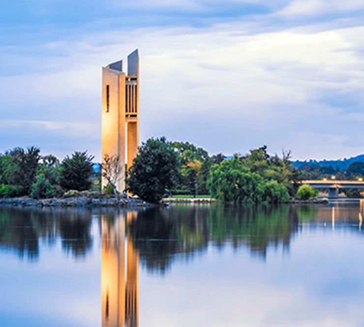 View of the National Carillion reflected in Lake Bruley Griffin at dawn in Canberra, Australia. 