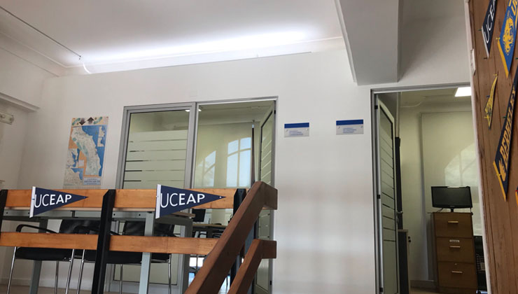 Inside of Chile study center, UCEAP flags hanging from railing