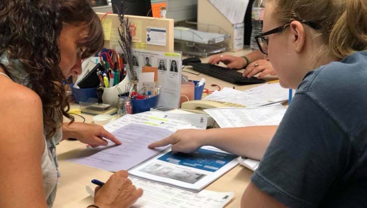 People work at a desk together in the study center. 