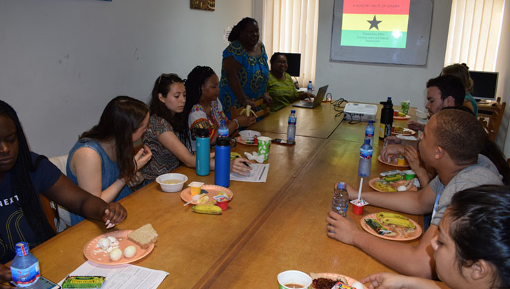 Students have a meal in the Ghana study center.