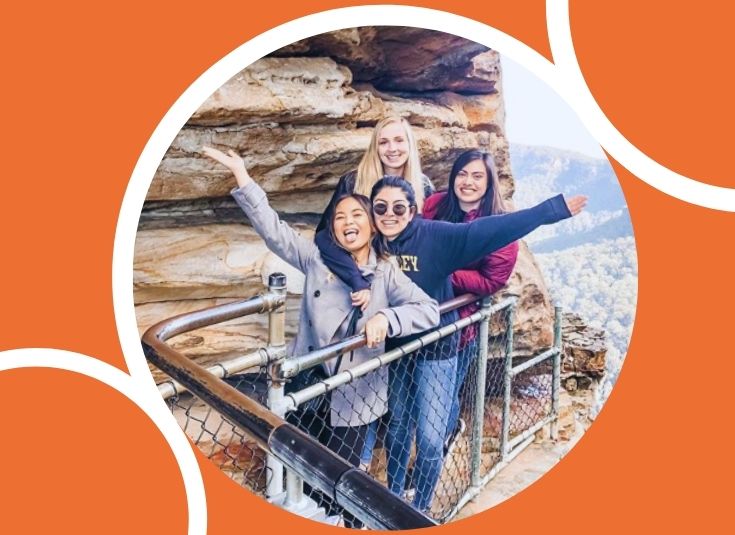 Group of students standing at a cliffside lookout in Australia.