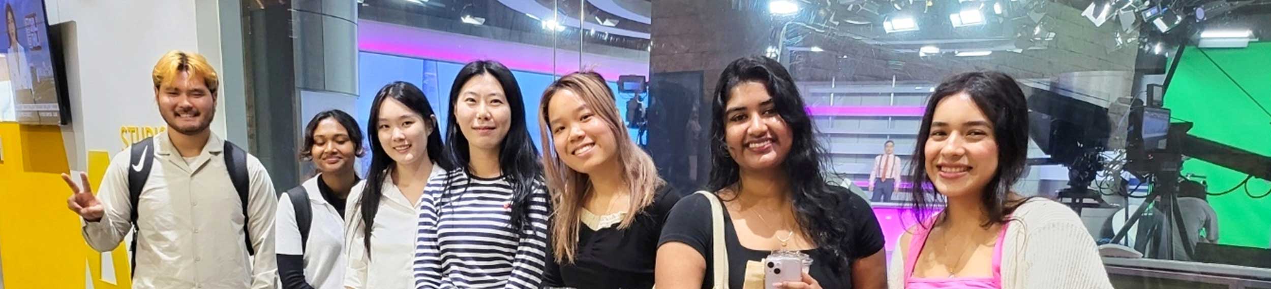 Group of diverse students in media production studio.