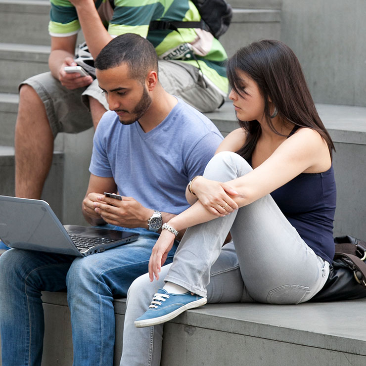 Two students looking at a computer. 