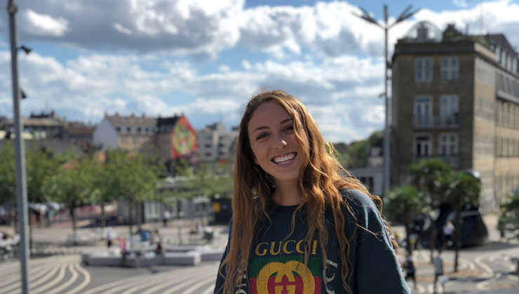Student poses in a Gucci sweatshirt at Superkilen Park in Copenhagen, Denmark.