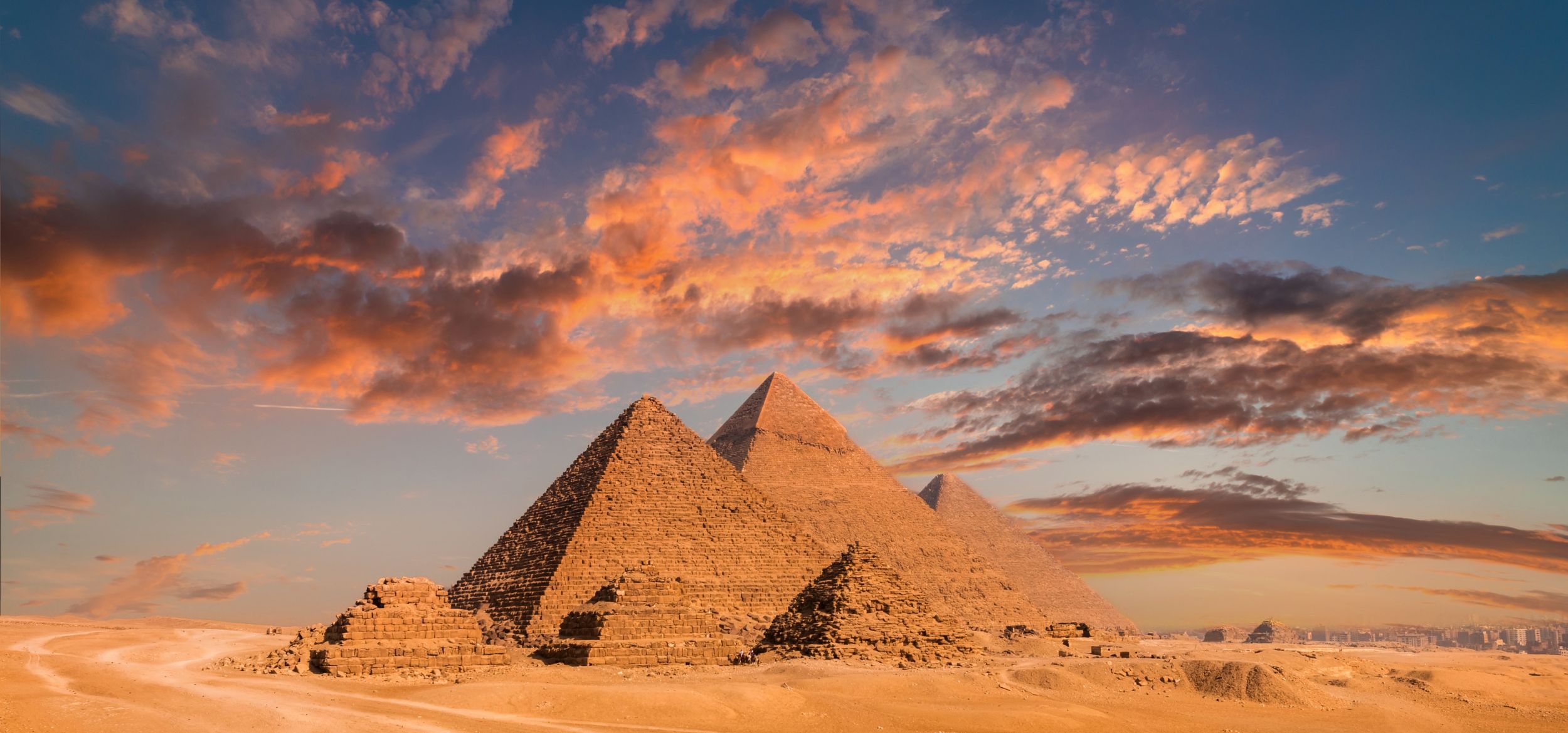 Sunlit clouds move over the Pyramids of Giza in Egypt.