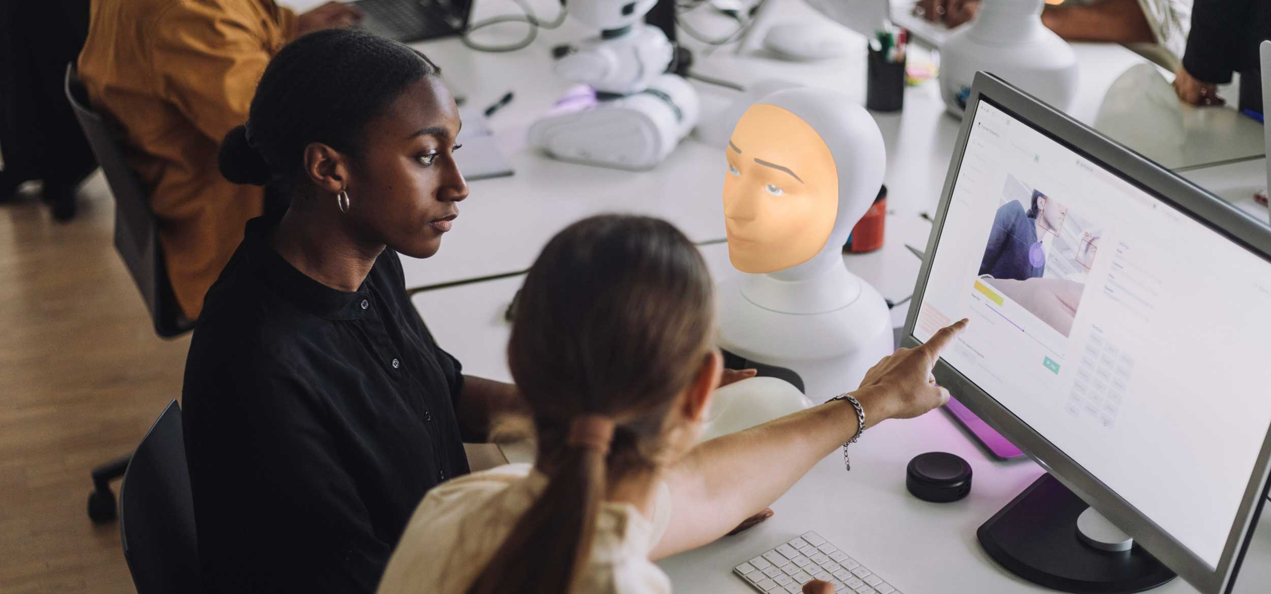 students discussing bioeningeering project at computer in innovation lab