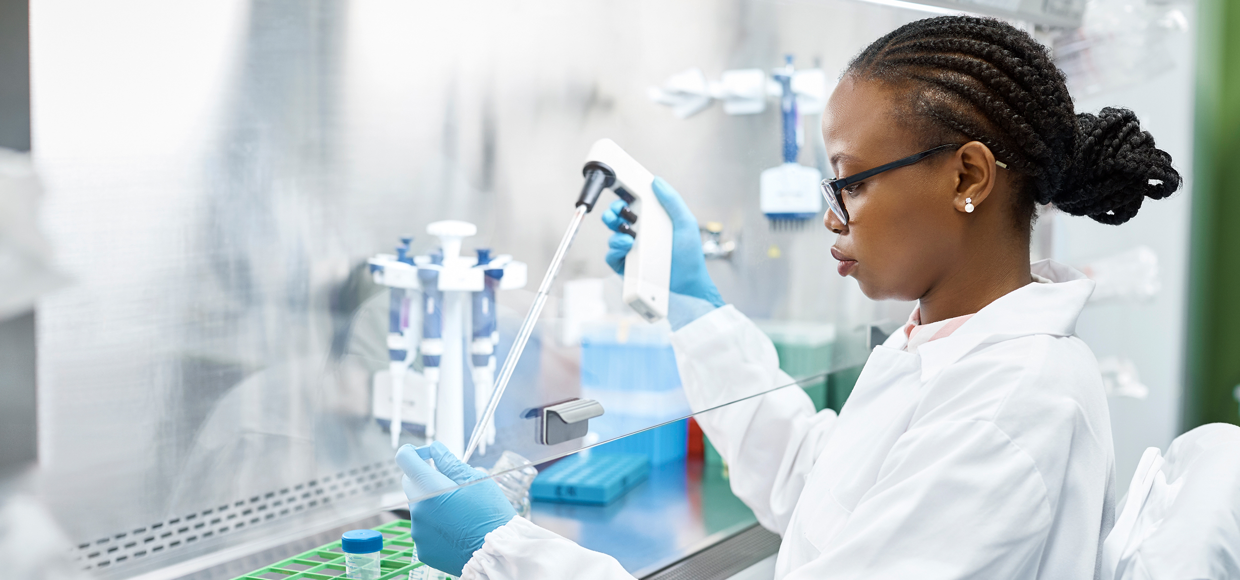 A young science student analyzing a medical sample in a test tube.