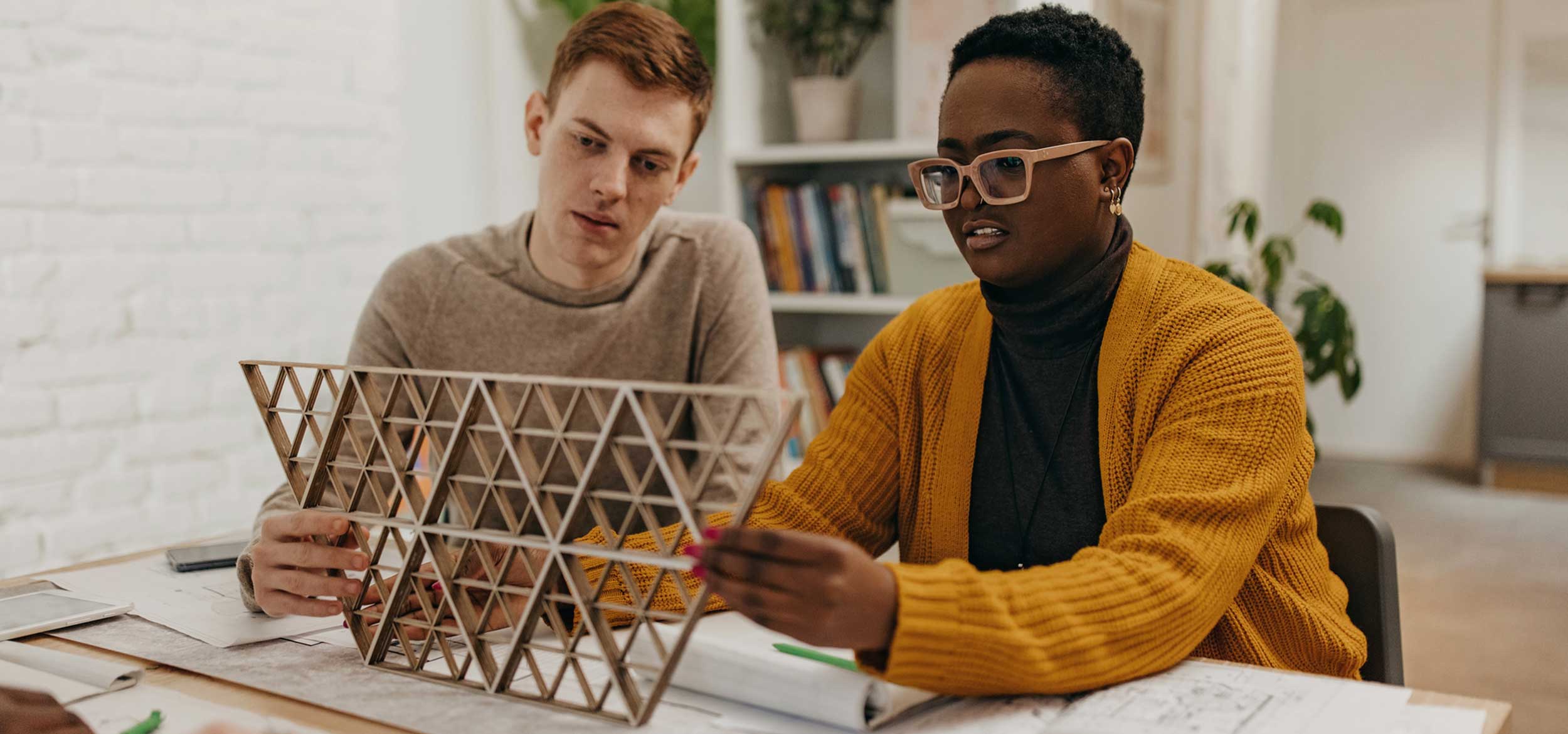Architecture students working on scale model.