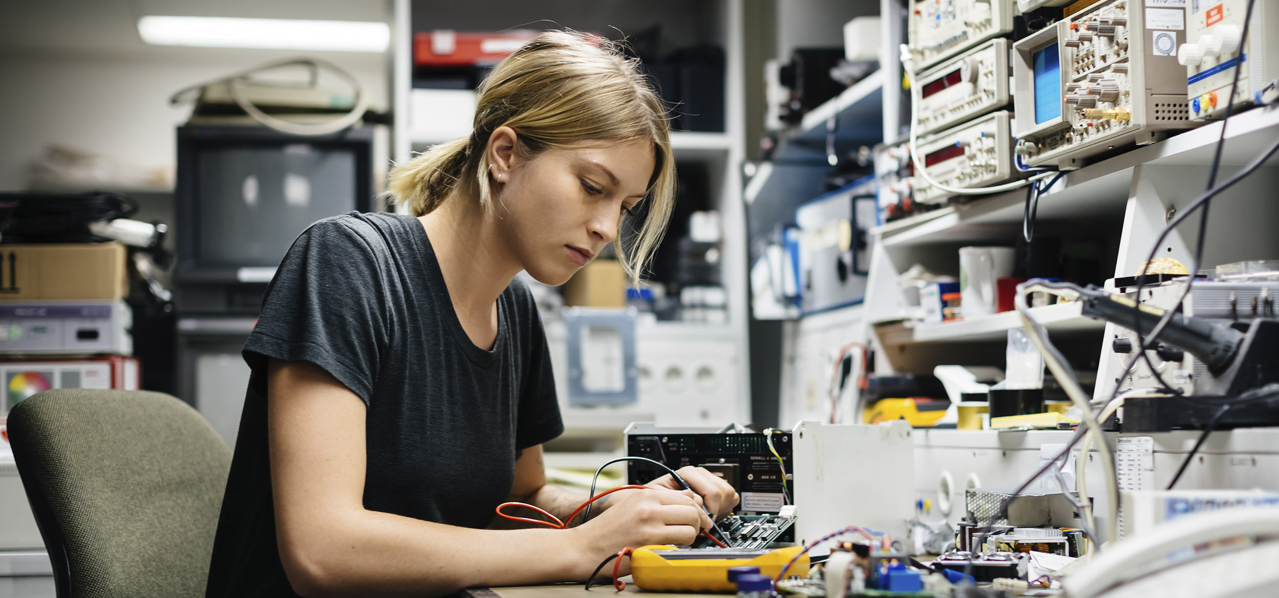 Student measures voltage on a conductor board in a workshop in Berlin, Germany. 