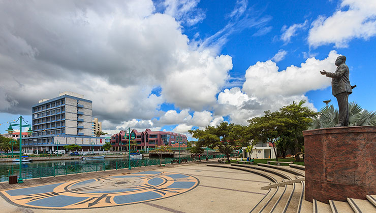 A floor paved with geometric patterns, two large fountains, and the statue of Errol Walton Barrow, former Prime Minister of Barbados.