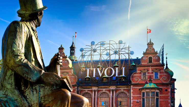 Tivoli Gardens with statue in foreground in Copenhagen, Denmark.