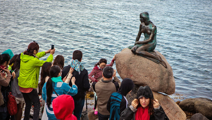 Tourists near the Little Mermaid Statue in Copenhagen, Denmark.