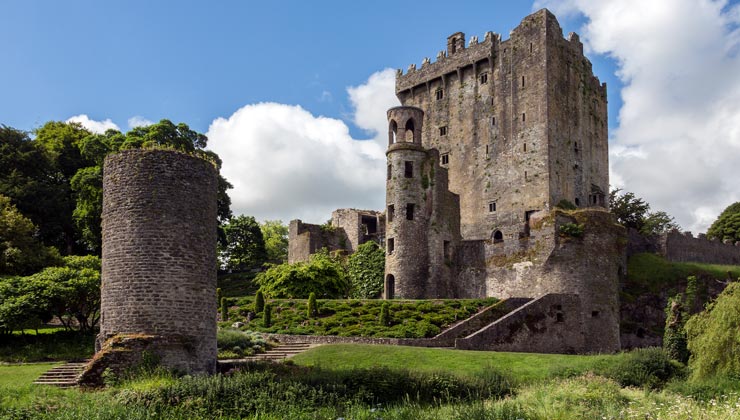 View of Blarney Castle around green plants in Cork, Ireland.