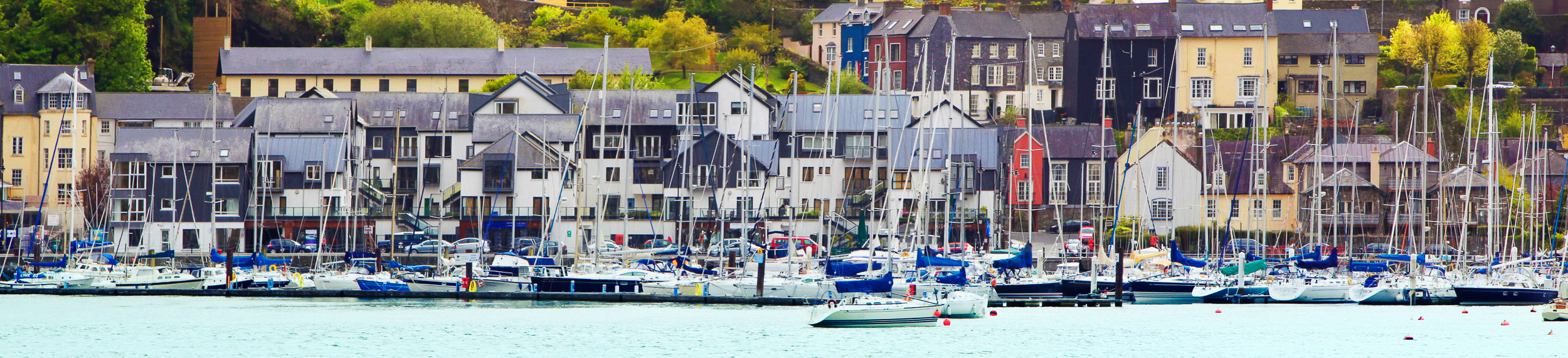 Boats and houses near the waterfront in Cork, Ireland. 