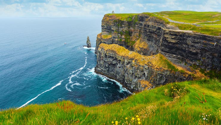 View of the lush green sea cliffs of Cliffs of Moher in Ireland.