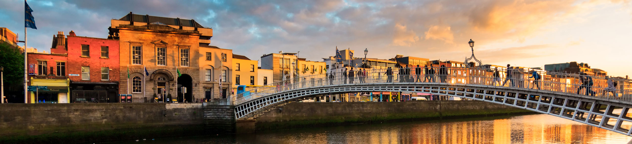 View of Ha'penny Bridge at sunset in Dublin, Ireland. 