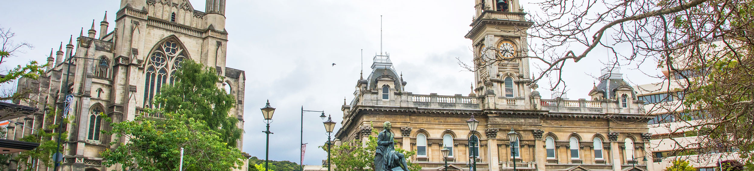 Robert Burns statue, Dunedin Town Hall and St. Paul's Cathedral in Dunedin New Zealand. 