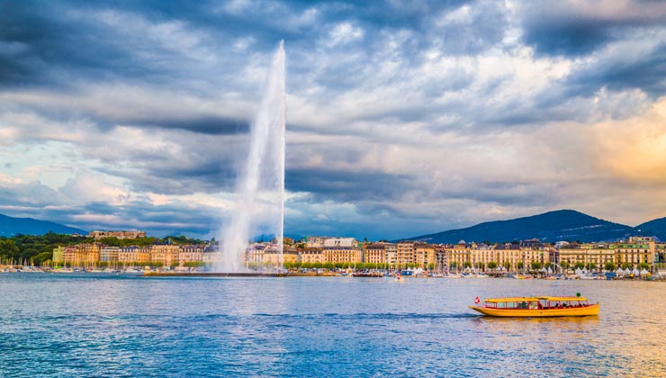 View of the lake with a boat in the foreground in Geneva, Switzerland.