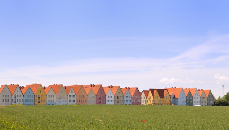 Jakriborg and colorful houses near a grassy field in Lund, Sweden. 