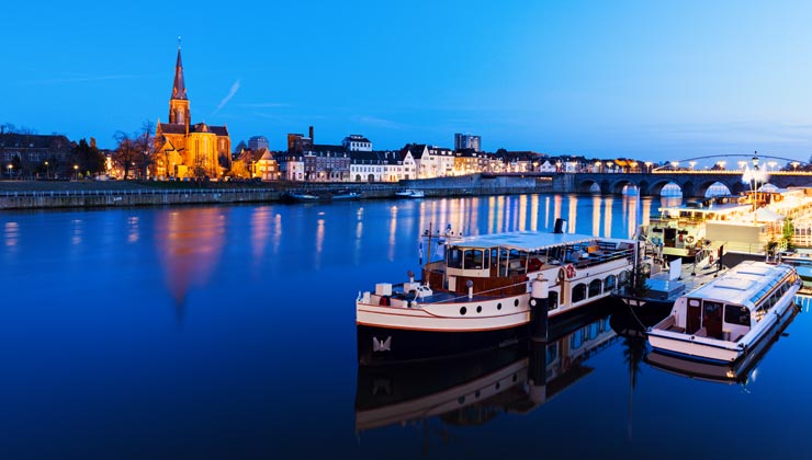 Boats and buildings near the Meuse River in Maastricht, Netherlands.