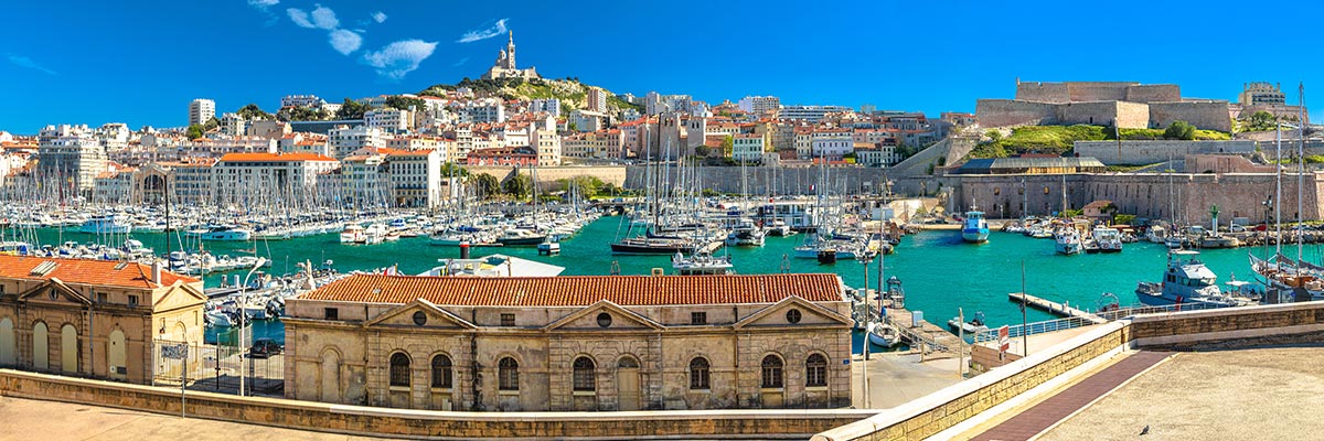  View of City of Marseille harbor and Notre Dame de la Garde church on the hill above the water.