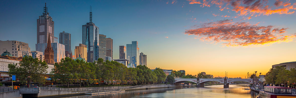 Urban skyline of Melbourne at sunset over the Yarra River. 