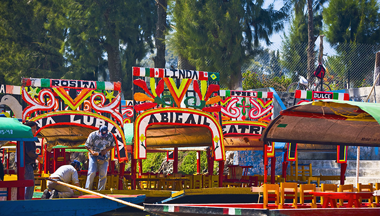 Two men on a trajineras boat at Xochimilco Gardens in Mexico City.