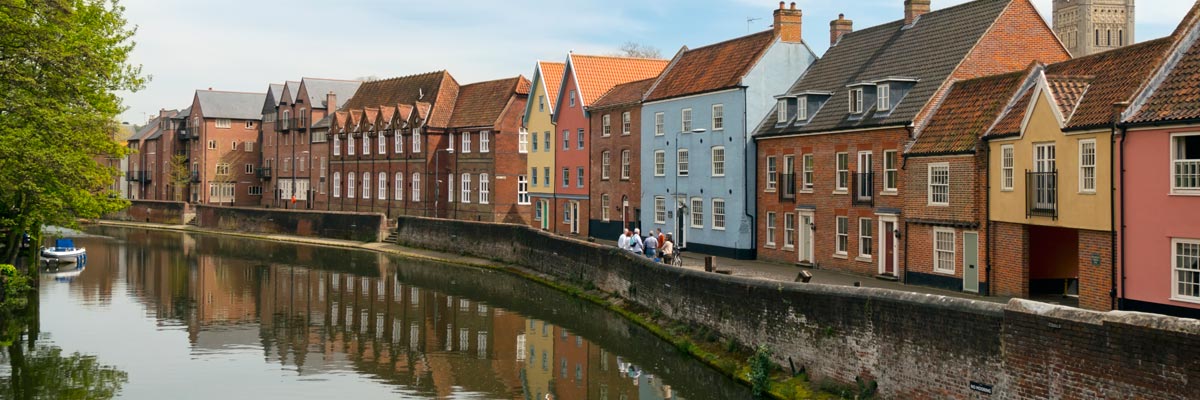 Row houses along the River Wensum in the old town of Norwich, Norfolk, England, UK