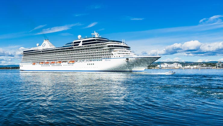 A big cruise ship overtaken by a speedboat in Oslo fjord, Norway.