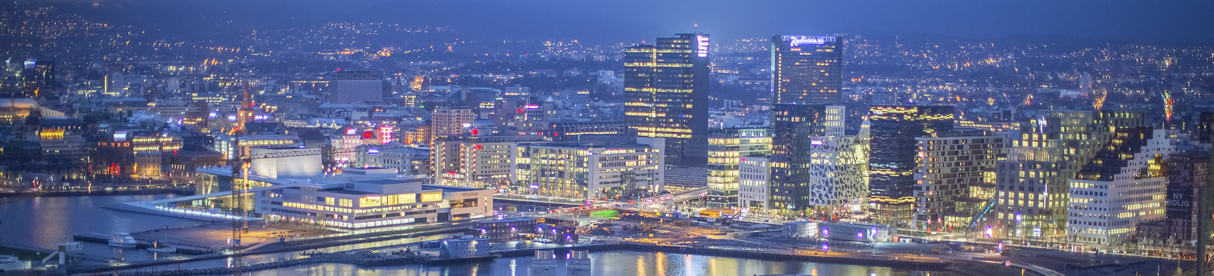 A view of the Oslo business district at dusk. 