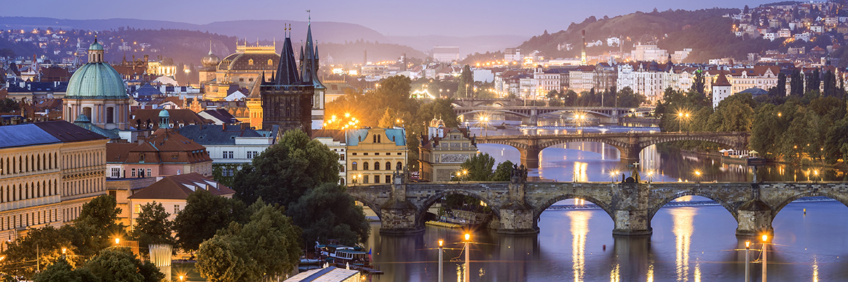 View above Prague just before sunrise, including Charles Bridge and Vltava River.