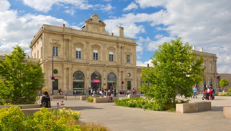 View of the front of Reims Railway Station  with a courtyard in Reims, France. 