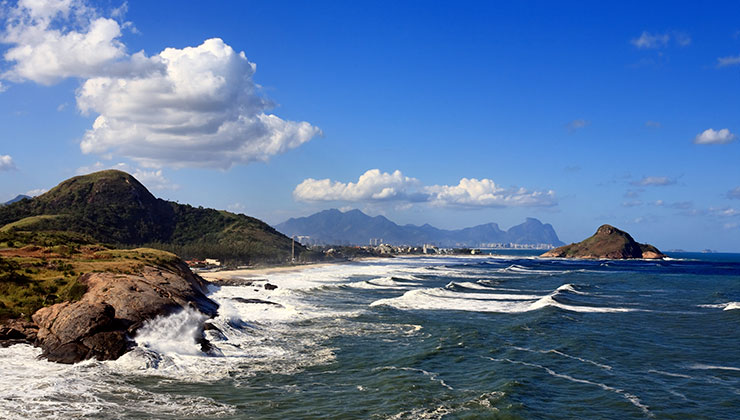 View of rocks near the water at Prainha Beach in Rio de Janeiro, Brazil. 