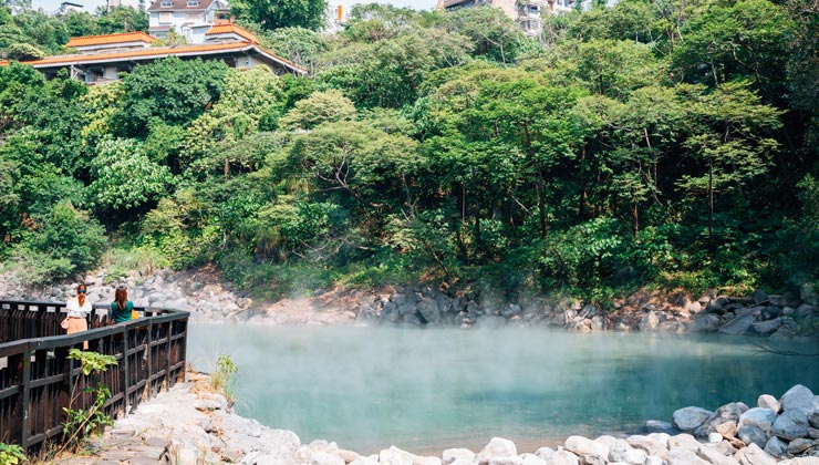 Beitou hot springs with trees and a viewing area in Taipei, Taiwan. 