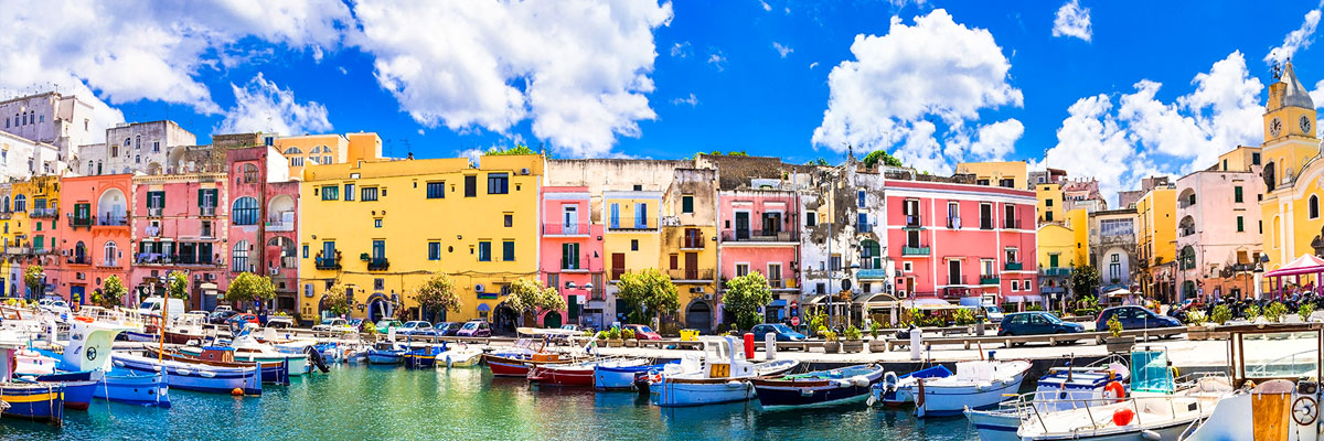 Boat dock area near colorful houses in Terra Murata, Italy.